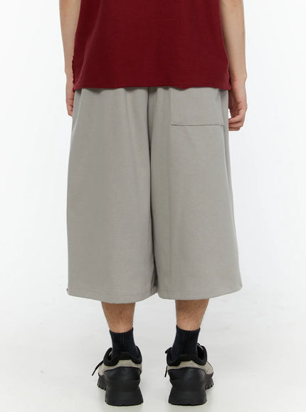 Men's Logo Embroidered Snap Hem Bermuda Sweat Shorts (Gray) IL507 gray back view on model showing patch pocket elastic waistband and snap hem detail