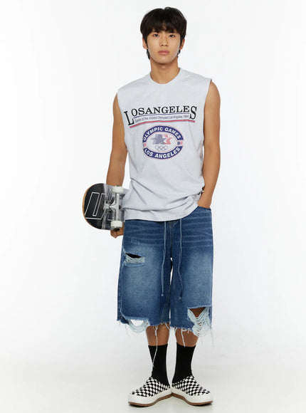 Men's Los Angeles Print Tank IL509 Light gray front shot on male model holding skateboard at side showing Olympic Games chest graphic and elongated hem