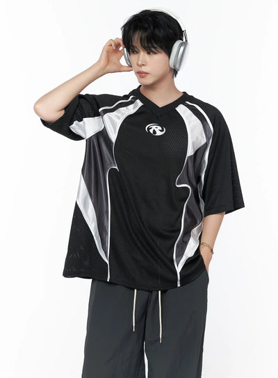 Men's Mesh Contrast V-Neck T-Shirt IU523 Black size L front shot on male model wearing headphones posed three-quarter turn with dark joggers