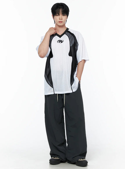Men's Mesh Contrast V-Neck T-Shirt IU523 White full-body front shot on male model with hand raised to chest styled with black wide-leg drawstring trousers