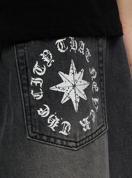 Men's 'Never Stop' Graphic Bermuda Jorts (Dark Gray) IL507 back pocket close-up detail showing circular old English gothic text and eight-pointed star graphic print