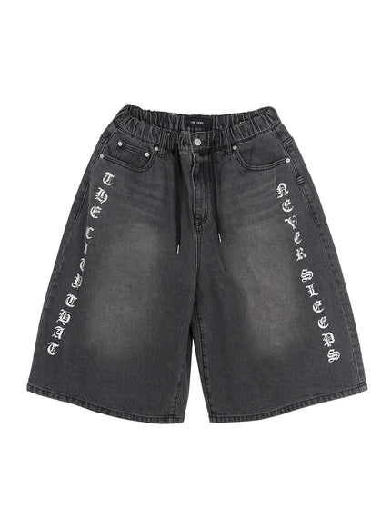 Men's 'Never Stop' Graphic Bermuda Jorts (Dark Gray) IL507 flat-lay front view showing elastic drawstring waistband vertical letter graphics on both legs washed dark gray denim