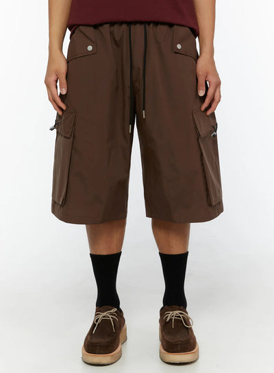 LEWKIN Men's Nylon Cargo Drawstring Bermuda Shorts (Dark Brown) IL507 Dark brown front close-up on model showing snap pockets and side cargo pockets with toggle closures