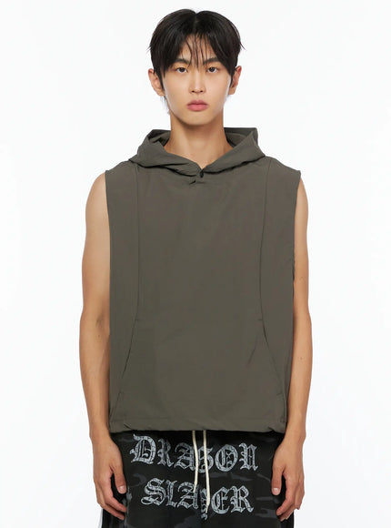 Men's Nylon Hooded Vest IL520 Dark green front half-body shot on male model showing snap button hood, seam lines, and kangaroo pocket
