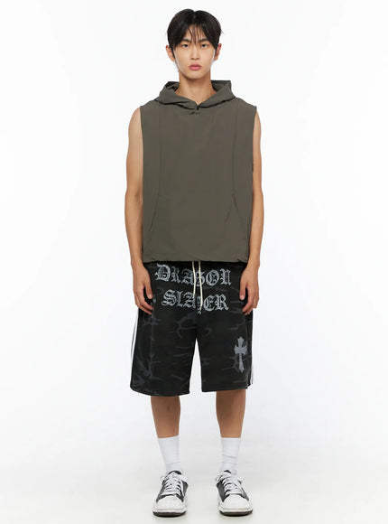 Men's Nylon Hooded Vest IL520 Dark green full-body front shot on male model standing straight, paired with camo shorts and sneakers