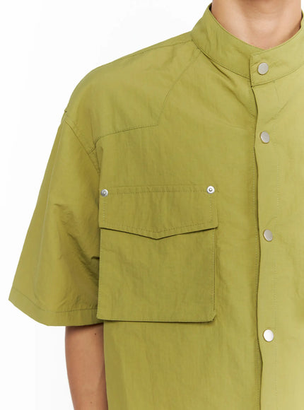 Men's Nylon Utility Shirt IL515 Olive Green close-up detail shot on model highlighting left chest flap pocket with silver snap buttons and band collar neckline