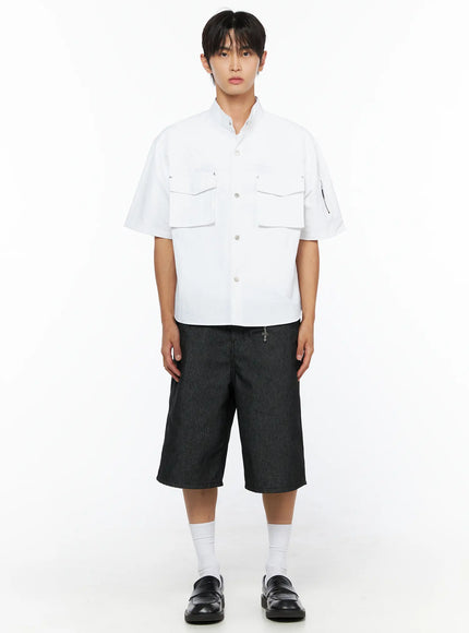 Men's Nylon Utility Shirt IL515 White full-body front shot on model standing straight, dual chest flap pockets and snap buttons visible, paired with striped shorts