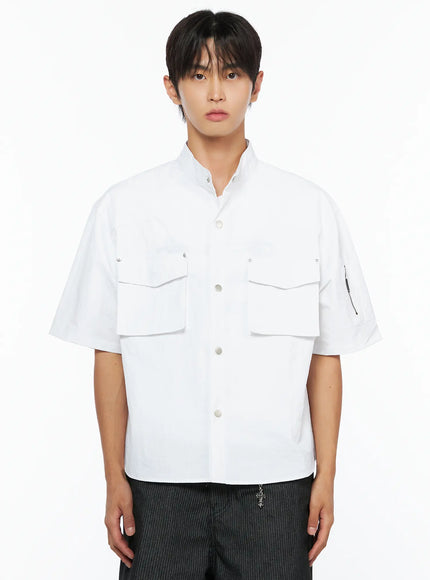 Men's Nylon Utility Shirt IL515 White close-up front shot on model showing band collar, dual flap chest pockets with snap closures, and center snap button placket