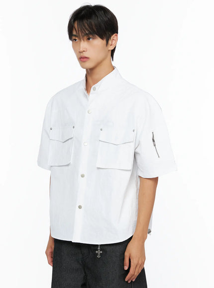 Men's Nylon Utility Shirt IL515 White three-quarter side shot on model showing dual chest pockets, silver snap buttons, and sleeve zipper pocket detail