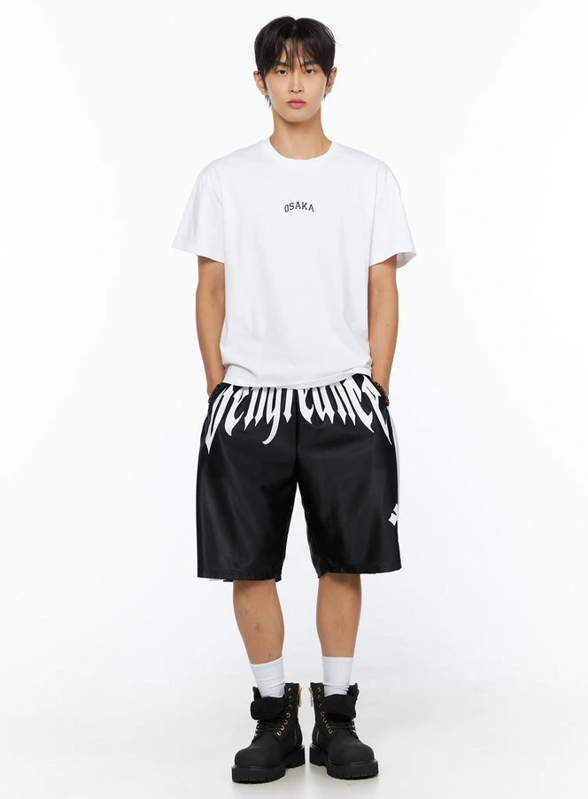 Men's Osaka Graphic T-Shirt IL520 White full-body front shot on model styled with black graphic shorts and black boots, relaxed fit cotton tee