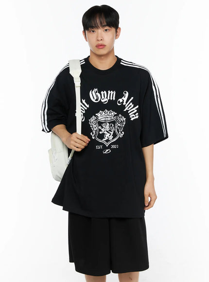 LEWKIN Men's Oversized Athletic Tee IL514 Black front shot on male model wearing backpack, oversized fit with white stripe sleeves and gothic Volt Gym Alpha crest print