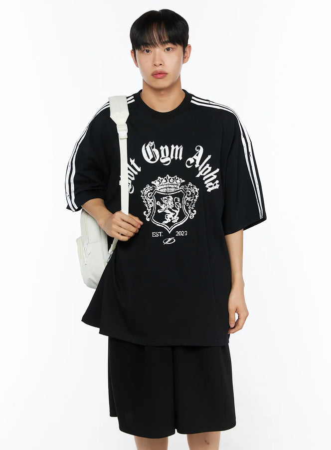 LEWKIN Men's Oversized Athletic Tee IL514 Black front shot on male model wearing backpack, oversized fit with white stripe sleeves and gothic Volt Gym Alpha crest print