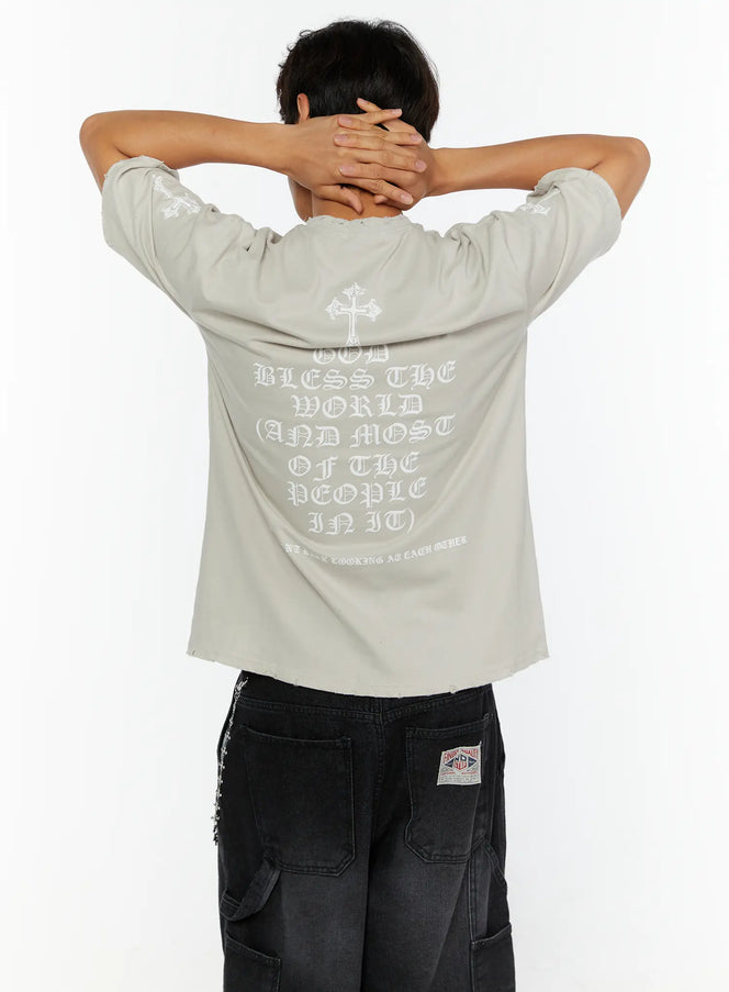 Men's Oversized Graphic T-Shirt IL513 back model shot showing gothic old English text God Bless The World print and cross graphic on beige colorway