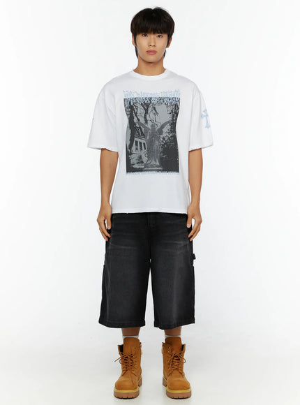 Men's Oversized Graphic T-Shirt IL513 White full-body front model shot styled with black denim shorts and tan boots showing angel graphic oversized tee