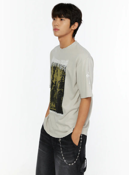 Men's Oversized Graphic T-Shirt IL513 side model shot in light beige with green-toned angel statue graphic and white cross sleeve print oversized fit