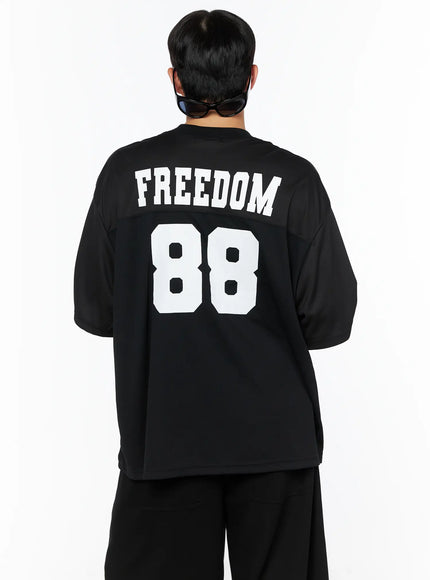 Men's Oversized Mesh Rugby Tee IL514 Black back shot on male model, large white FREEDOM 88 varsity print on oversized mesh jersey, styled with black wide-leg pants