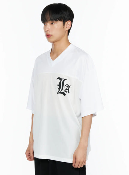 Men's Oversized Mesh Rugby Tee IL514 White side shot on male model, V-neck and dropped shoulder silhouette, black La gothic logo visible on chest panel, relaxed oversized fit