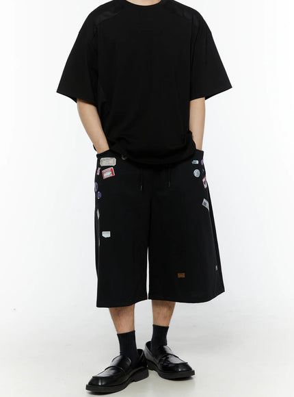 Men's Oversized Mesh Tee (Black) IL509 front view on male model styled with black patch shorts and loafers showing oversized silhouette