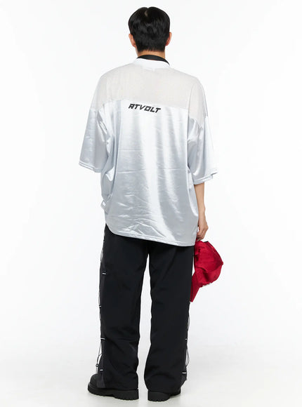 Men's Oversized Sports Jersey Tee IL514 Silver back shot on male model showing RTVOLT logo and mesh yoke panel with black cargo pants holding red cap