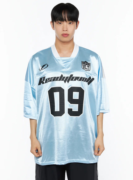 Men's Oversized Sports Jersey Tee IL514 Blue front shot on male model showing Readytoovolt 09 graphic VLT badge V-neck and light blue satin oversized fit