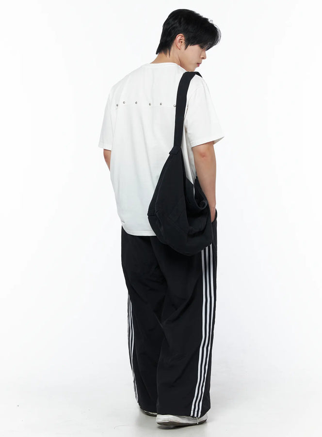 LEWKIN Men's Oversized Studded Tee IL502 White back shot on male model wearing black stripe wide-leg pants and crossbody bag standing pose