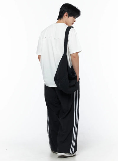 LEWKIN Men's Oversized Studded Tee IL502 White back shot on male model wearing black stripe wide-leg pants and crossbody bag standing pose