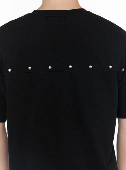 Men's Oversized Studded Tee IL502 Black back detail close-up showing row of silver dome studs along upper yoke seam on heavyweight cotton fabric