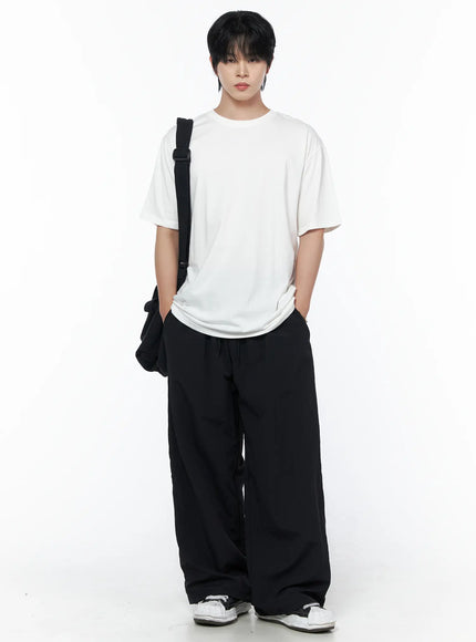 Men's Oversized Studded Tee IL502 White front shot on male model full-body standing with black crossbody bag hands in pockets street style outfit