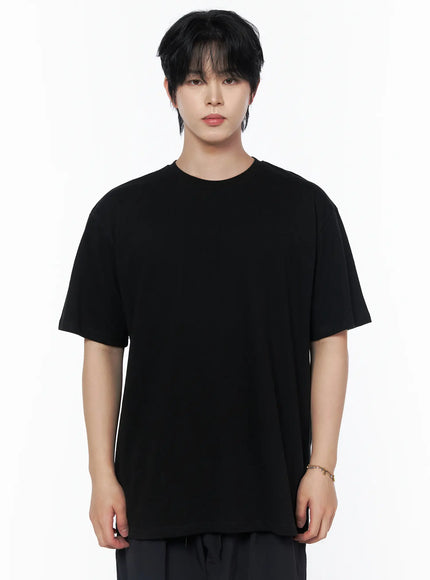 Men's Oversized Studded Tee IL502 Black front crop shot on male model upper-body standing pose showing oversized boxy silhouette and round crew neck