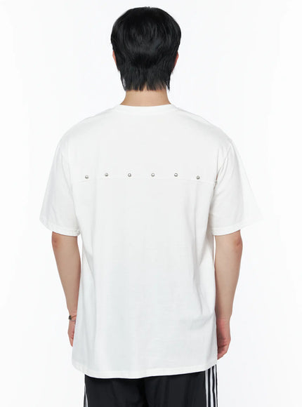 Men's Oversized Studded Tee IL502 White back shot on male model close-up showing row of silver studs along upper back yoke seam detail