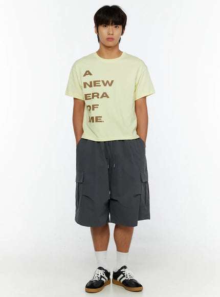Men's Parachute Cargo Shorts IL515 Dark gray full-body front shot on male model standing straight, styled with yellow graphic tee and black sneakers