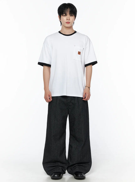 Men's Patch Detail Short Sleeve Tee IU523 White front view on male model standing upright, black ringer crewneck and cuffs, chest pocket with leather brand patch, styled with pinstripe pants
