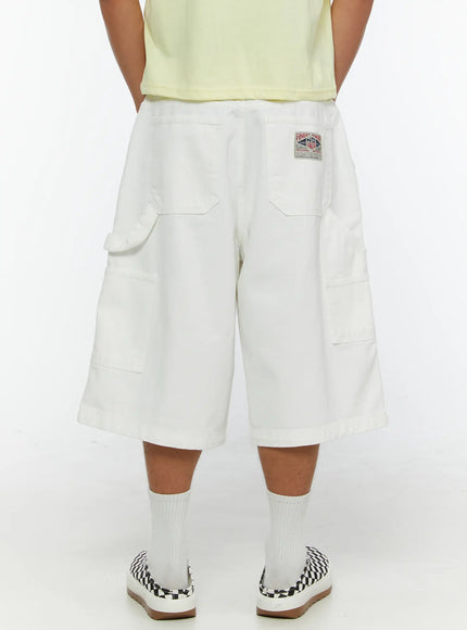LEWKIN Men's Patch Pocket Jorts IL515 White back view on model with hands in pockets, styled with yellow tee and checkered slip-on shoes