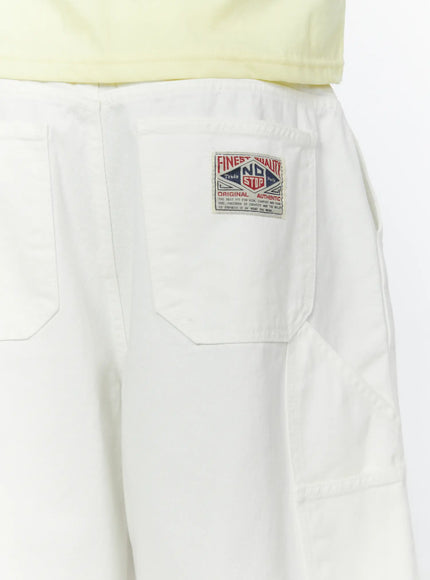 Men's Patch Pocket Jorts IL515 White close-up detail of back waistband showing Finest Quality No Stop woven label patch on rear pocket