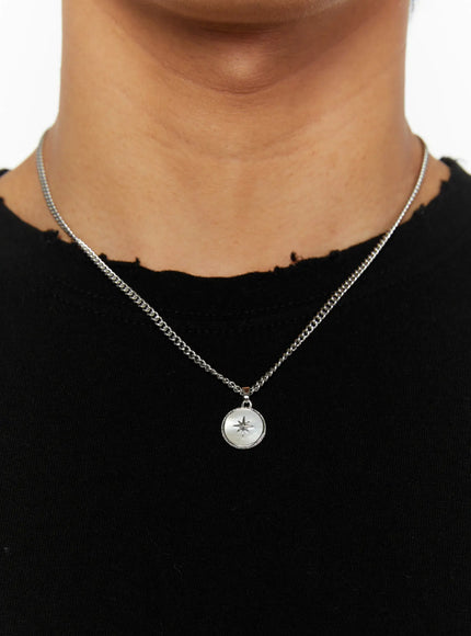LEWKIN Men's Pendant Necklace IL510 Silver close-up on model neck with round north star medallion pendant on curb chain over black distressed top