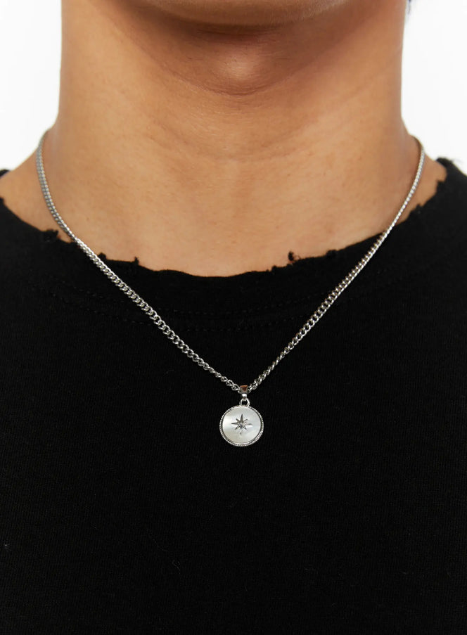 LEWKIN Men's Pendant Necklace IL510 Silver close-up on model neck with round north star medallion pendant on curb chain over black distressed top