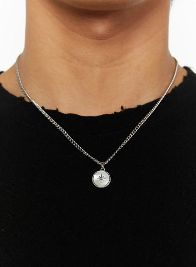 LEWKIN Men's Pendant Necklace IL510 Silver close-up on model neck with round north star medallion pendant on curb chain over black distressed top