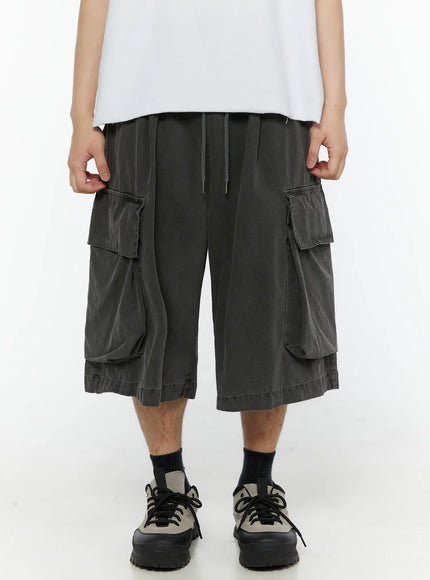 Men's Pigment Bermuda Cargo Shorts (Dark Gray) IL507 Dark gray front model shot waist-down showing dual cargo pockets drawstring waist and wide-leg washed cotton silhouette