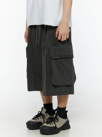 Men's Pigment Bermuda Cargo Shorts (Dark Gray) IL507 Dark gray side close-up on model showing large flap cargo pocket and drawstring elastic waistband detail