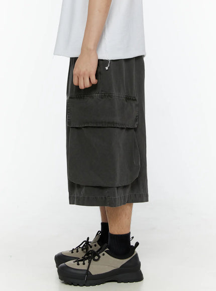 Men's Pigment Bermuda Cargo Shorts (Dark Gray) IL507 Dark gray left side model shot highlighting oversized flap cargo pocket layered hem and pigment-dyed washed texture