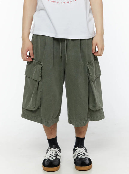 Men's Pigment Bermuda Cargo Shorts (Dark Green) IL507 Dark green front view on male model showing dual cargo pockets drawstring waist washed cotton fabric