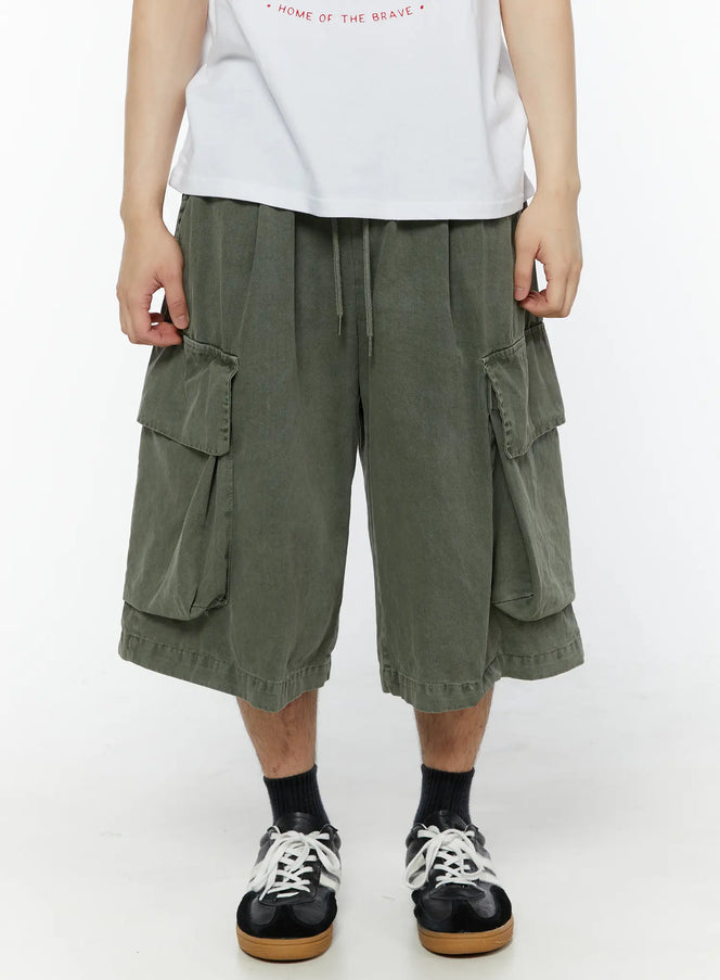 Men's Pigment Bermuda Cargo Shorts (Dark Green) IL507 Dark green front view on male model showing dual cargo pockets drawstring waist washed cotton fabric