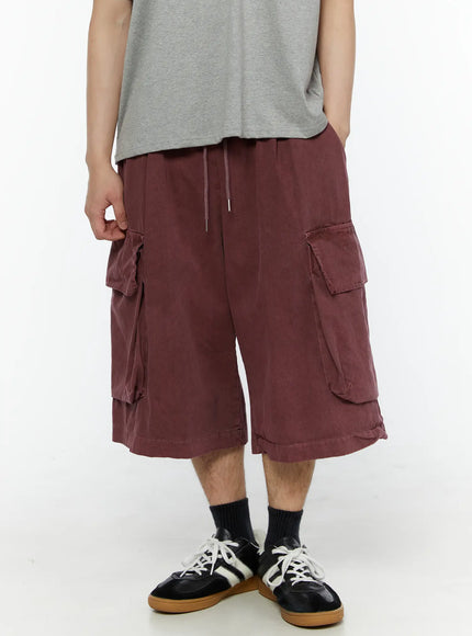 LEWKIN Men's Pigment Bermuda Cargo Shorts (Dark Pink) IL507 Dark Pink M/L front view on model paired with gray tee and sneakers, washed cotton cargo pockets