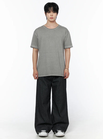 Men's Pigment Washed T-Shirt IU523 Gray full-body front shot on male model arms at sides showing washed cotton texture paired with black pinstripe wide-leg pants