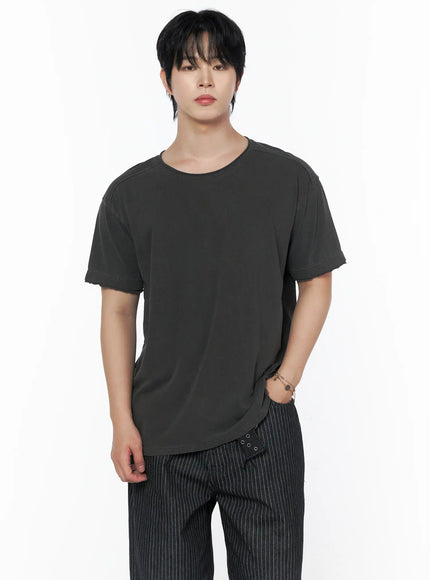 Men's Pigment Washed T-Shirt IU523 Charcoal front shot on male model half-body showing deep round neckline shoulder seams and raw-edge sleeve cuffs in dark pigment wash
