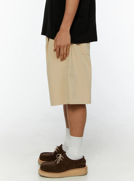 Men's Pintuck Cotton Bermuda Shorts IL515 Beige back view on model showing two patch pockets with stitched detail and wide leg cotton bermuda silhouette