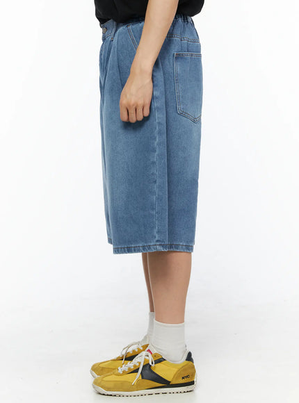 Men's Pintuck Jorts IL510 Blue side view on model showing back patch pocket, elastic waistband detail, and wide-leg denim cut