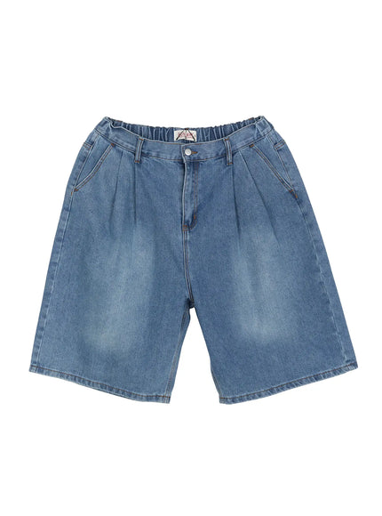 Men's Pintuck Jorts IL510 Blue flat-lay front view showing pintuck pleats, elastic waistband, snap button, and brand label on washed blue denim