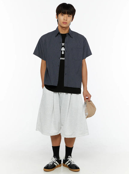 Men's Pintuck Wide Jorts IL510 light gray full-body front view on male model styled with plaid shirt black tee and sneakers holding cap