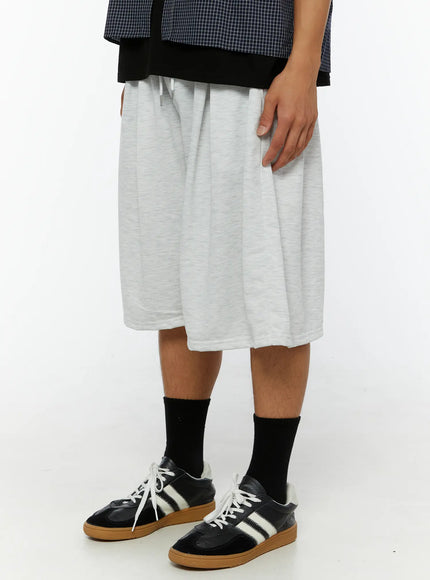 Men's Pintuck Wide Jorts IL510 light gray side view on male model showing wide-leg drape and drawstring waist with heathered cotton texture